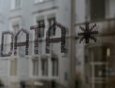 a close up of a window with a building in the background