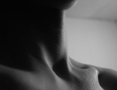 a black and white photo of a woman's neck