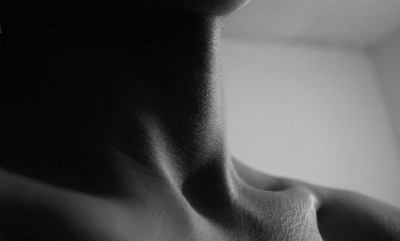 a black and white photo of a woman's neck