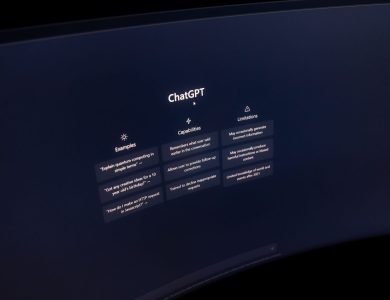 Close-up of a computer screen displaying ChatGPT interface in a dark setting.
