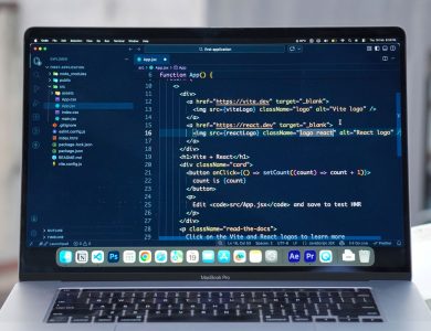 A MacBook Pro displaying code editor on a rooftop setting in daylight, ideal for a remote work lifestyle.