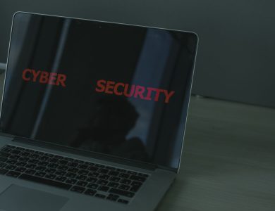 Close-up of a laptop displaying cybersecurity text, emphasizing digital security themes.