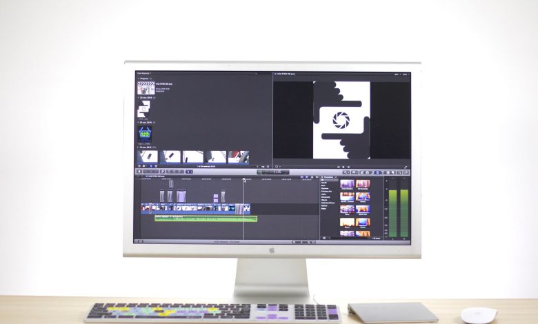 A sleek computer monitor displays video editing software in a modern workspace.