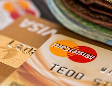 Macro shot of credit cards showing Visa and Mastercard logos next to a wallet, ideal for finance themes.