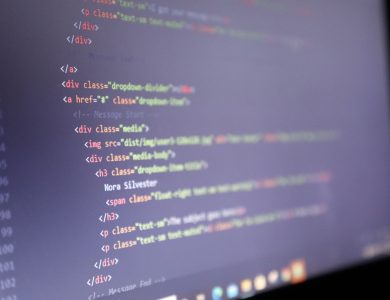 Illuminated HTML code displayed on a computer screen, close-up view.