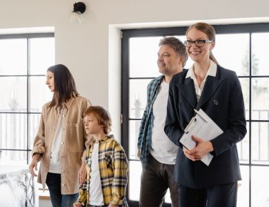 A family explores their new home with the help of a realtor, filled with excitement and anticipation.