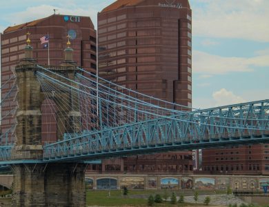 View of the iconic John A. Roebling Suspension Bridge with Cincinnati skyline in the background.