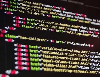 Close-up of HTML code highlighted in vibrant colors on a computer monitor.